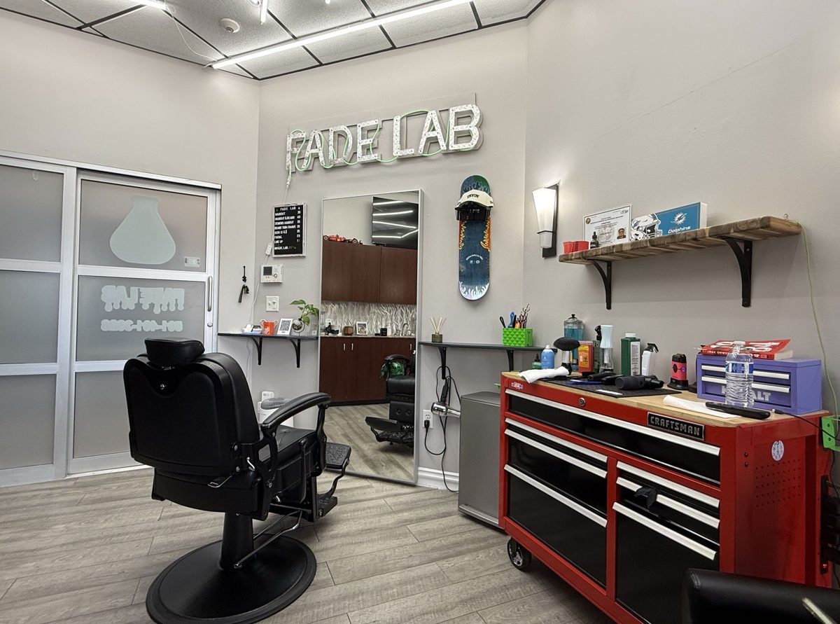 Inside Fade Lab 102 in Palm Beach Gardens, barber chair and FADE LAB wall sign